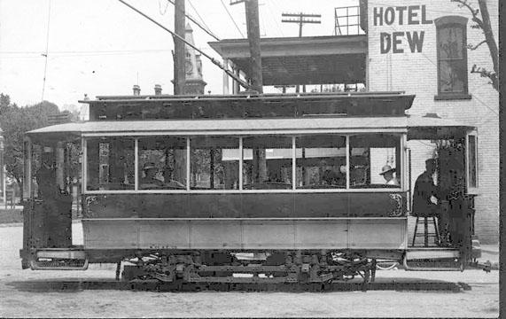 Picture of a trolley car beside the Dew Hotel in Nelsonville OH. The trolley belonged to the Hocking