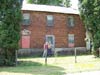 Kate-Lyn Briana Dew and her father Brian Austin Dew standing in front of the James Crabtree Dew hous